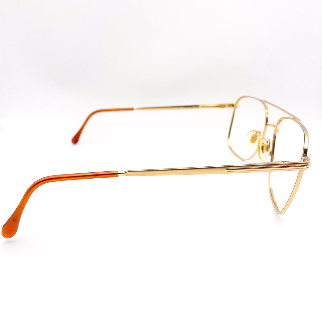 1980s gold-framed eyeglasses on a white background
