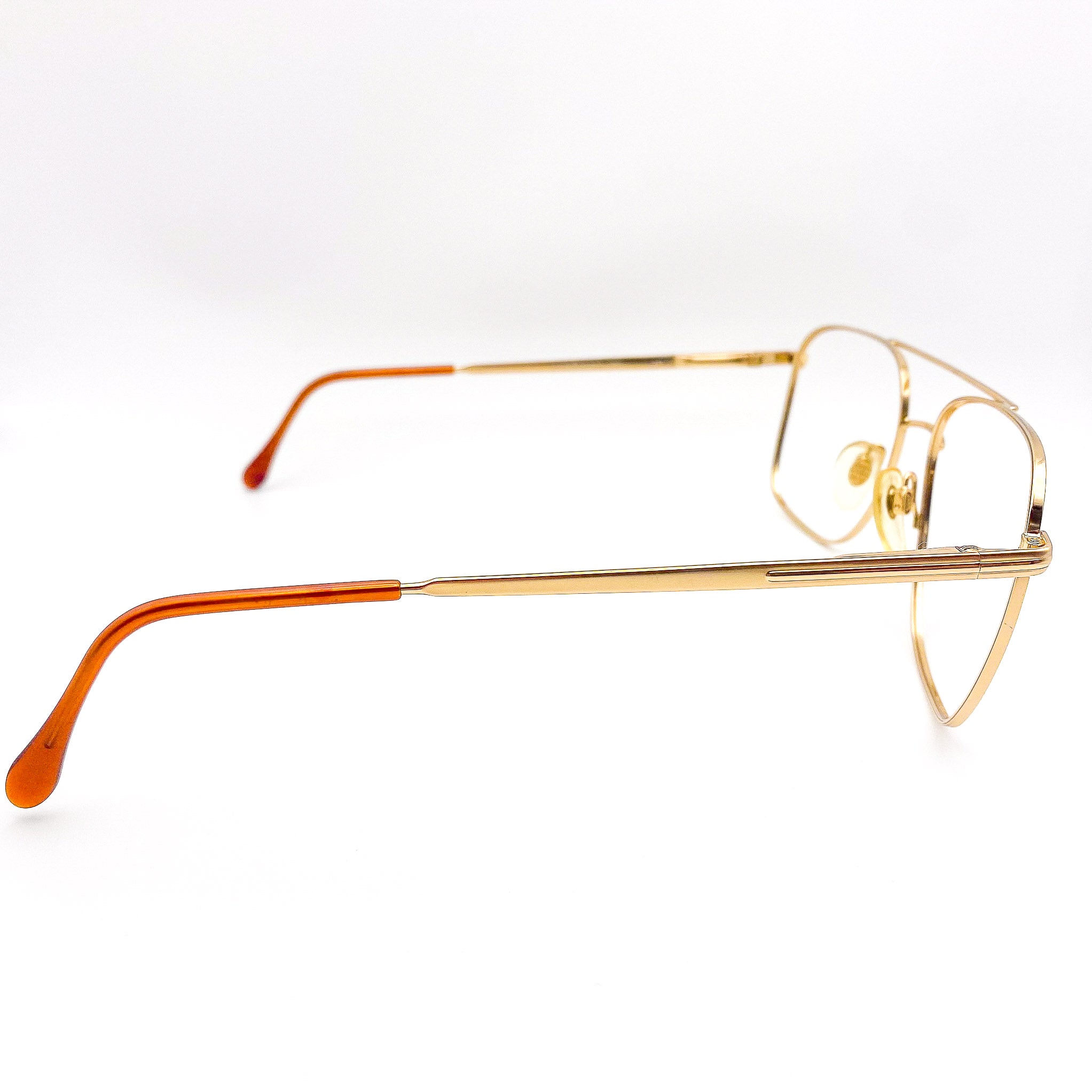 1980s gold-framed eyeglasses on a white background