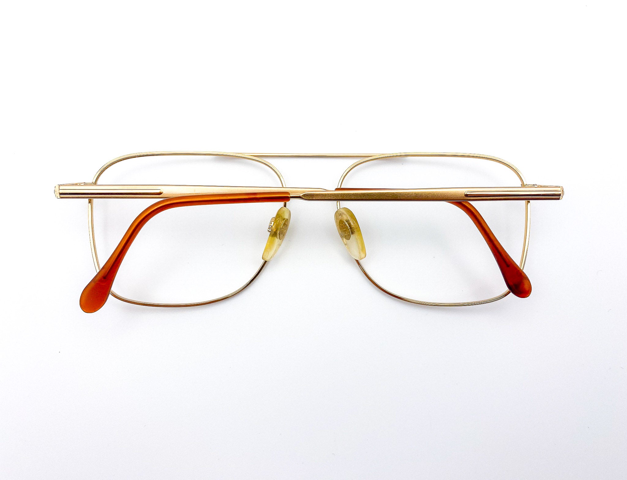 Gold-framed Luxottica eyeglasses on a white background