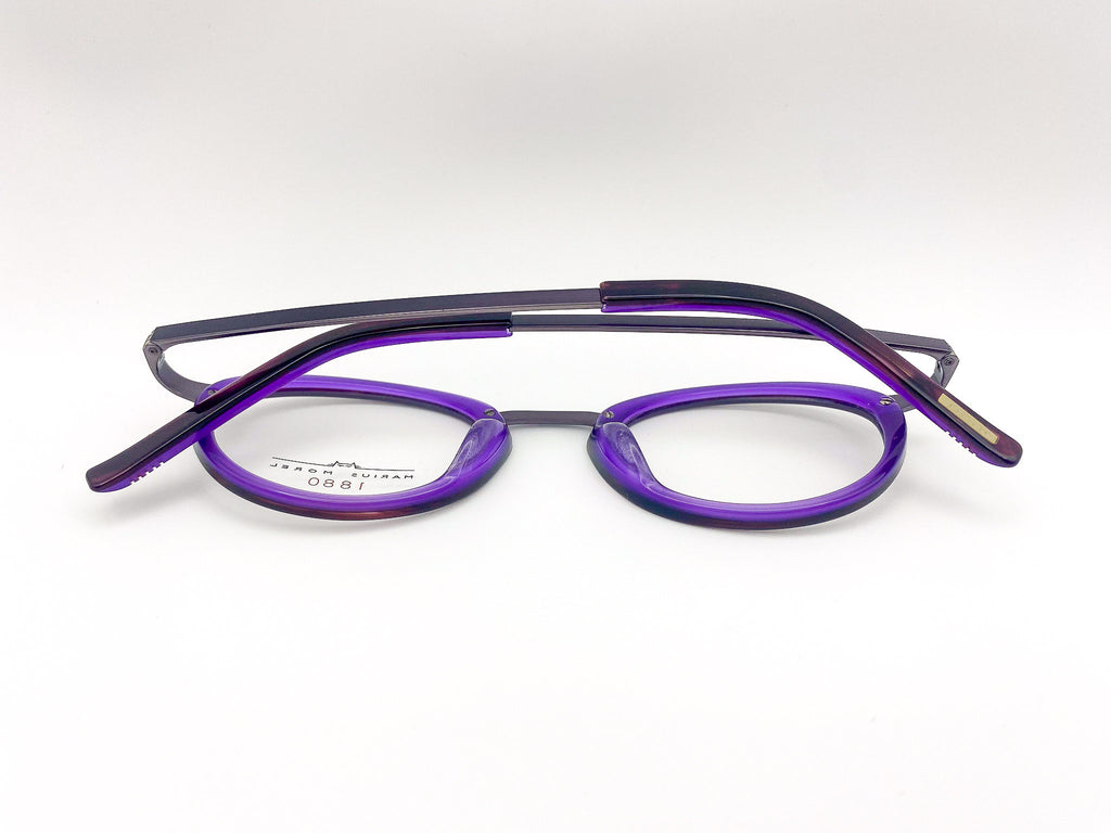 Purple and black eyeglasses on a white background