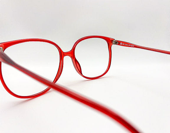 Red eyeglasses on a white background