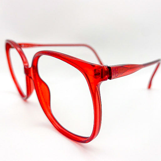 Vintage oversized red eyeglasses on a white background