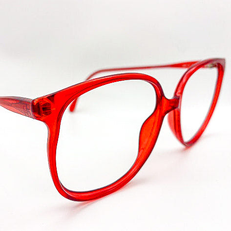 Red eyeglasses on a white background