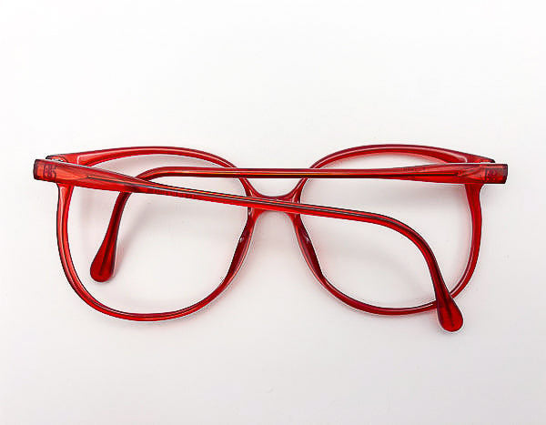 1980s red optyl eyeglasses on a white background