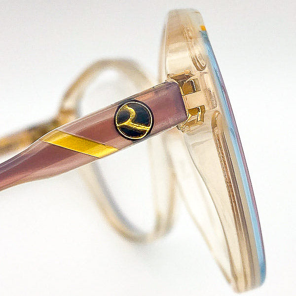 Close-up of the Rochas Paris 'R' logo on an eyeglass frame
