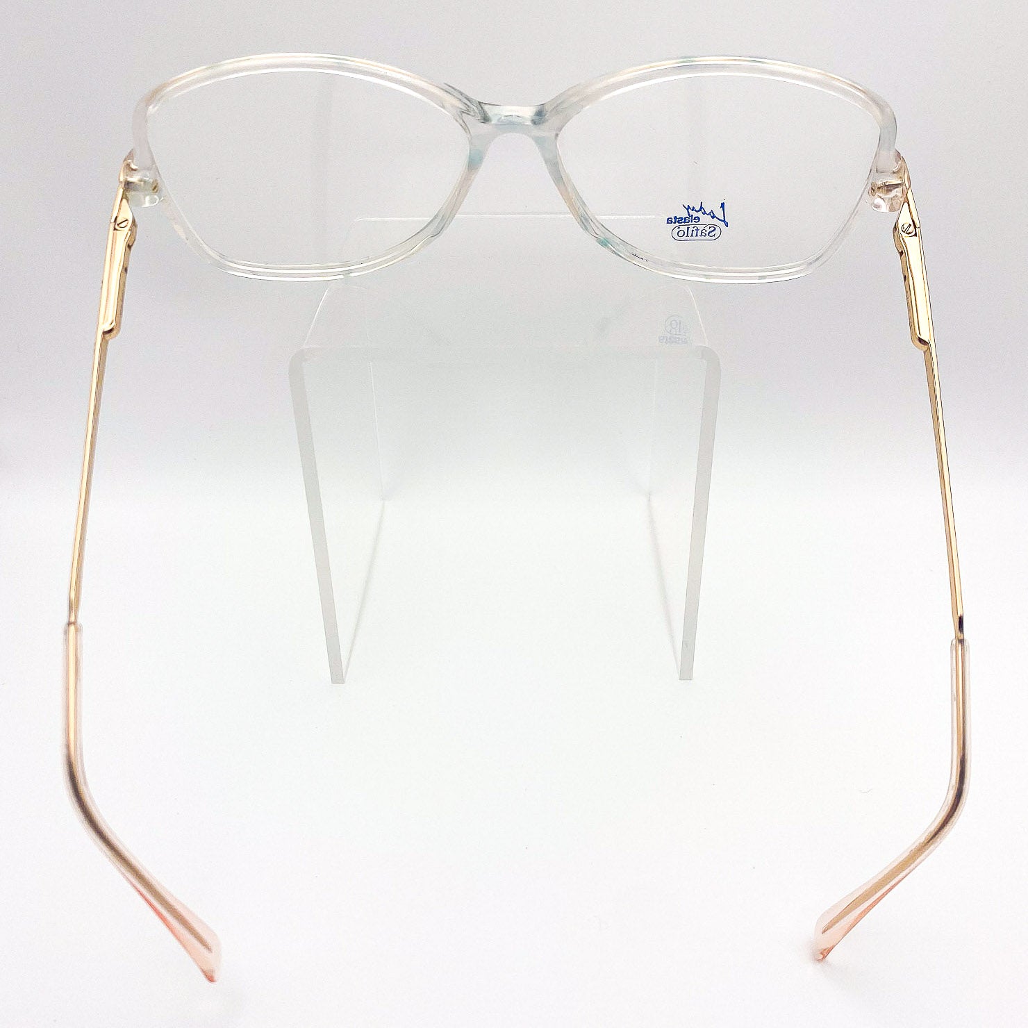Clear eyeglasses with gold frames on a white background