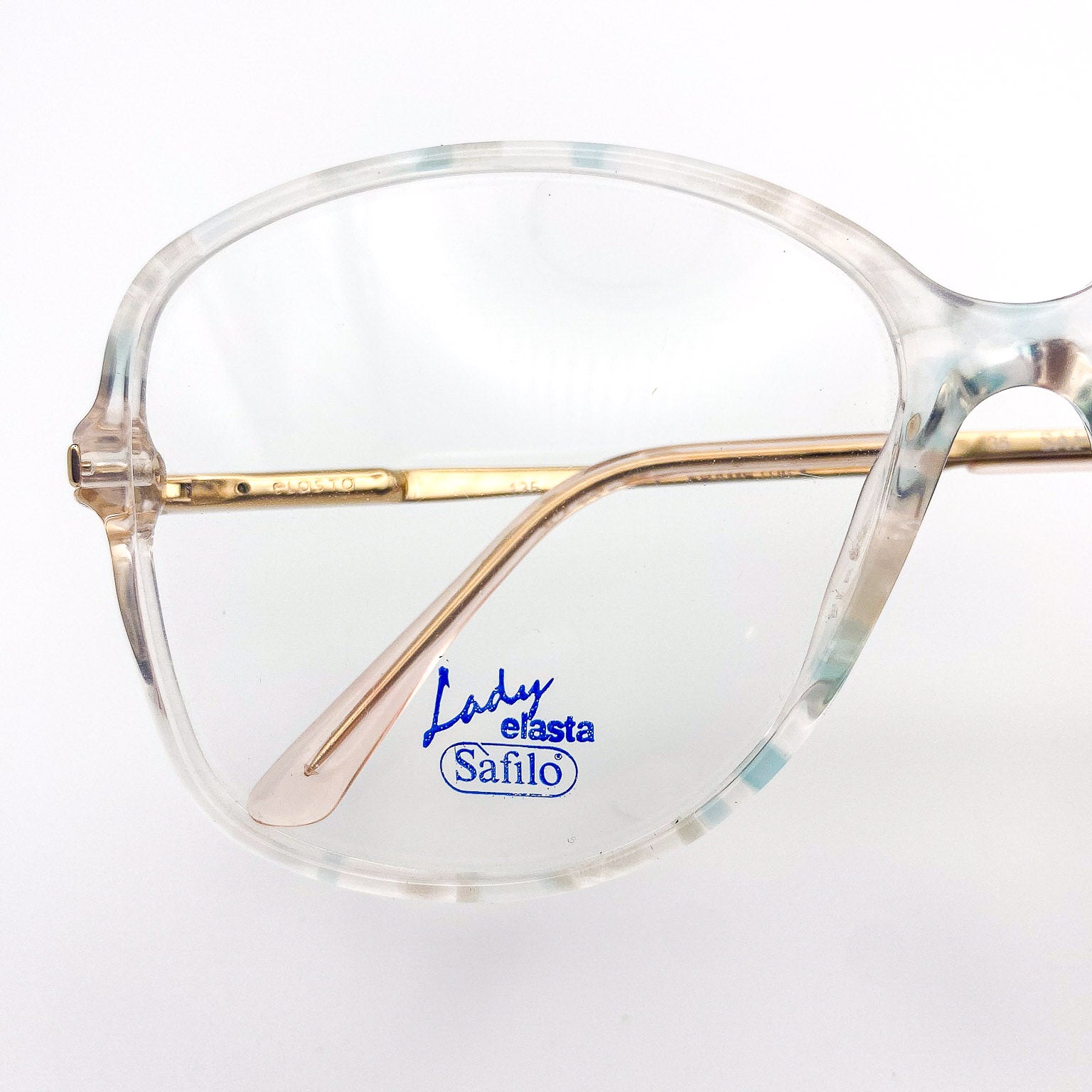 Eyeglasses with 'Safilo Lady Elasta' logo on a white background