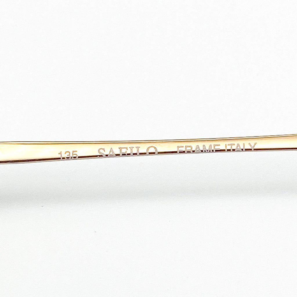 Gold frame with 'Safilo Frame Italy' engraving on a white background