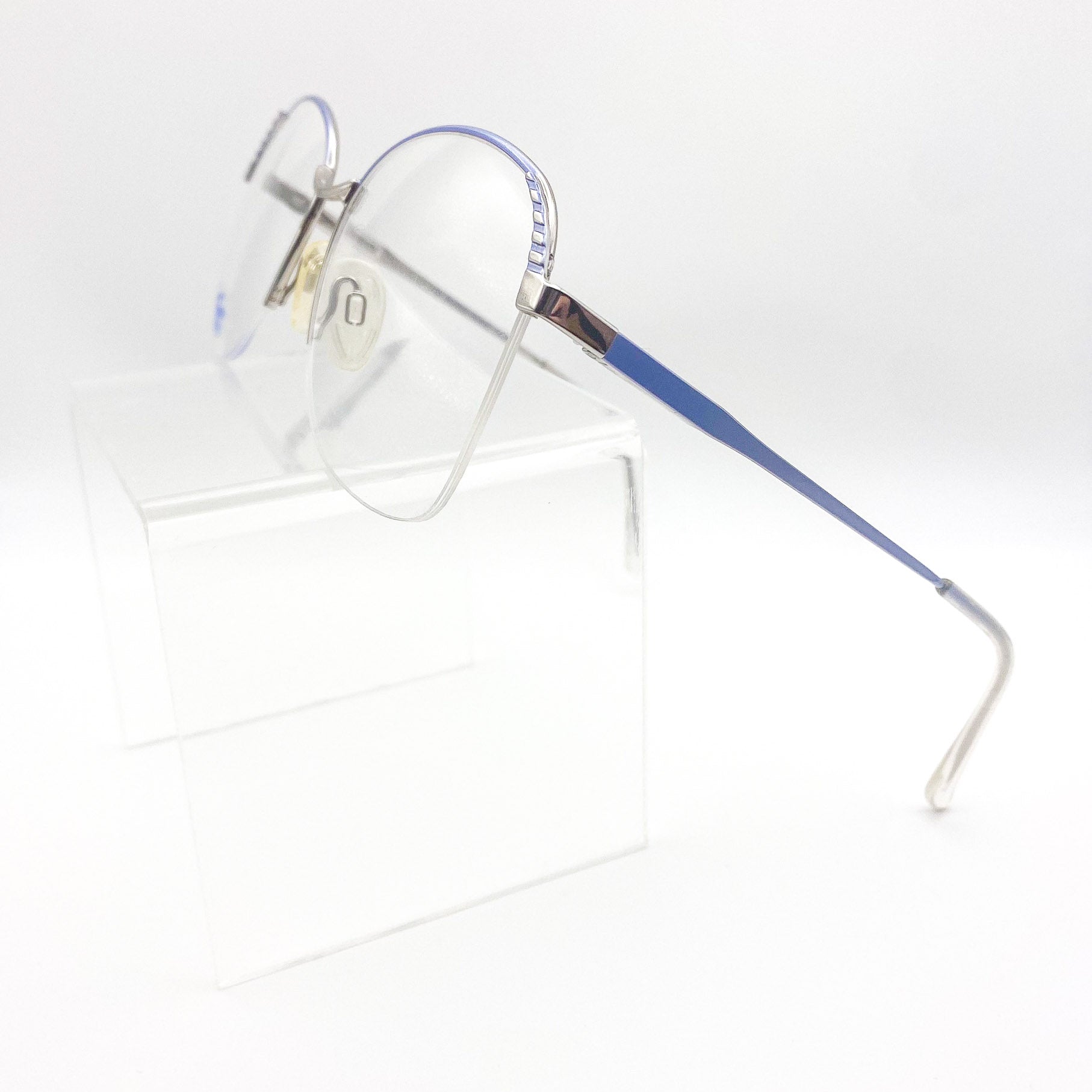 1980s silver eyeglasses with blue temples on a white background