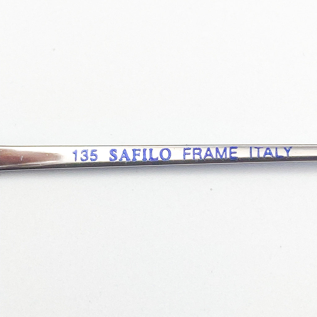 Metal frame with '135 SAFILO FRAME ITALY' engraving on a white background