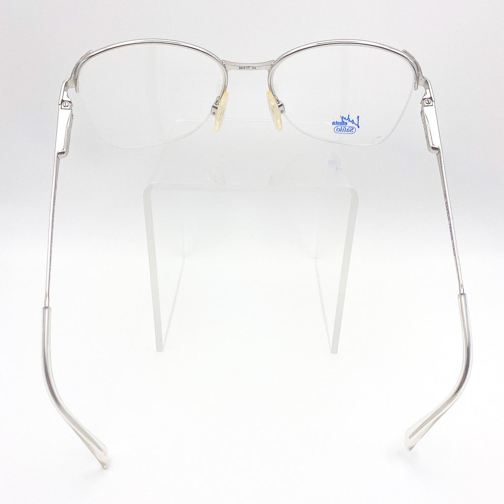 Silver butterfly-framed eyeglasses on a white background