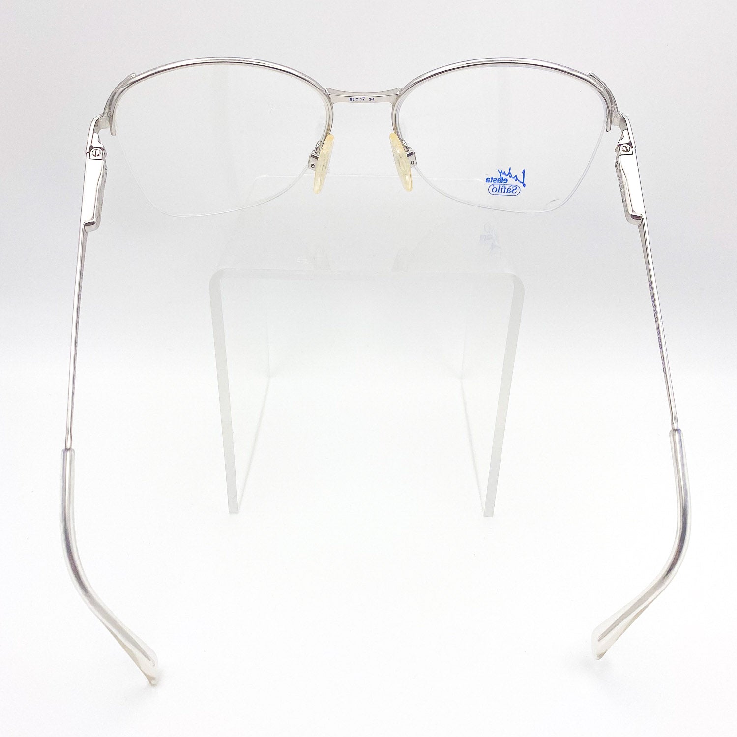Silver butterfly-framed eyeglasses on a white background
