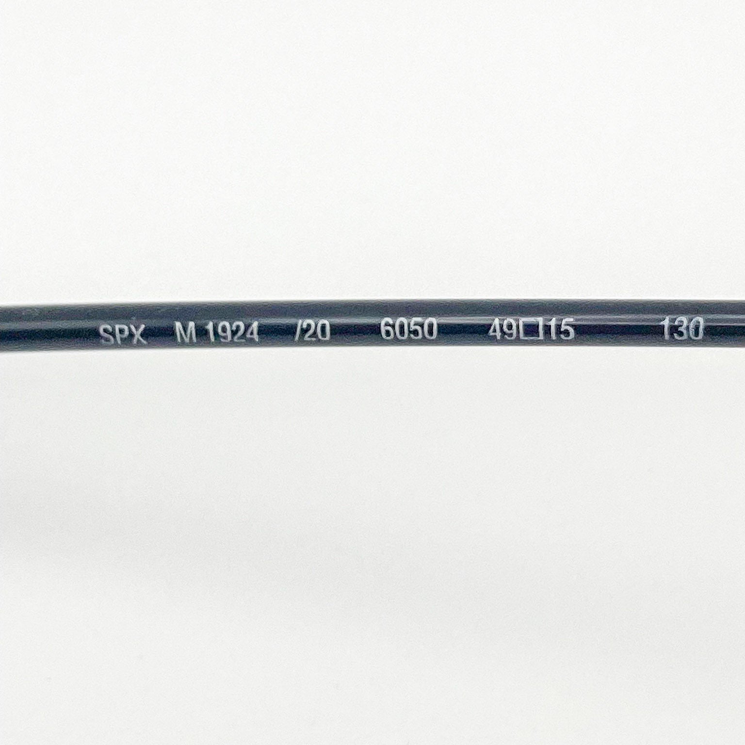 Close-up of a black temple arm with text on a white background