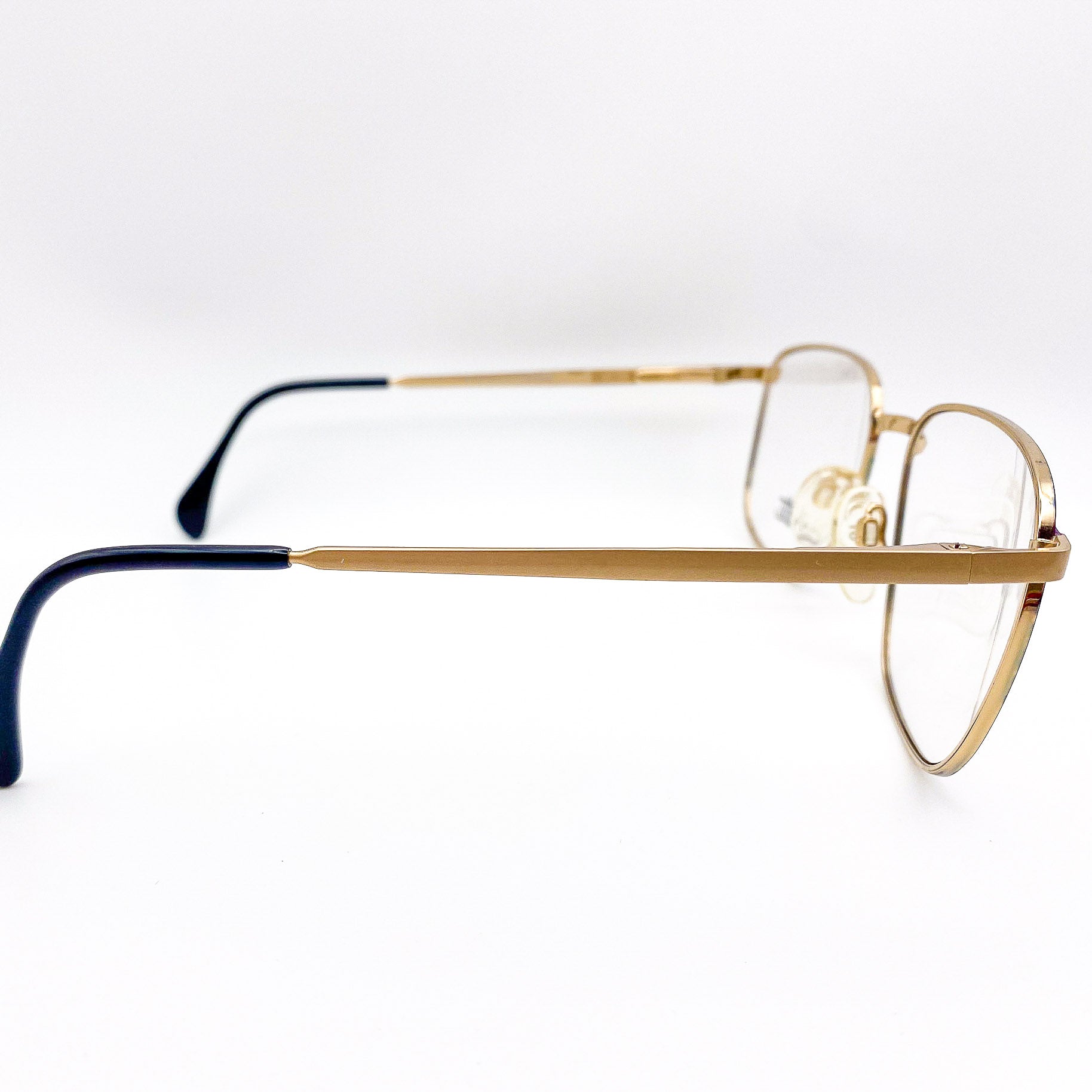 gold eyeglasses frame on a white background
