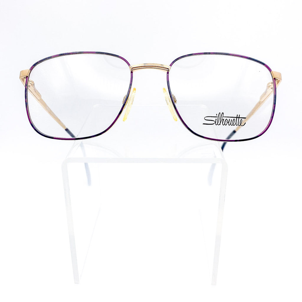 Silhouette eyeglasses with purple and gold frame on a white background