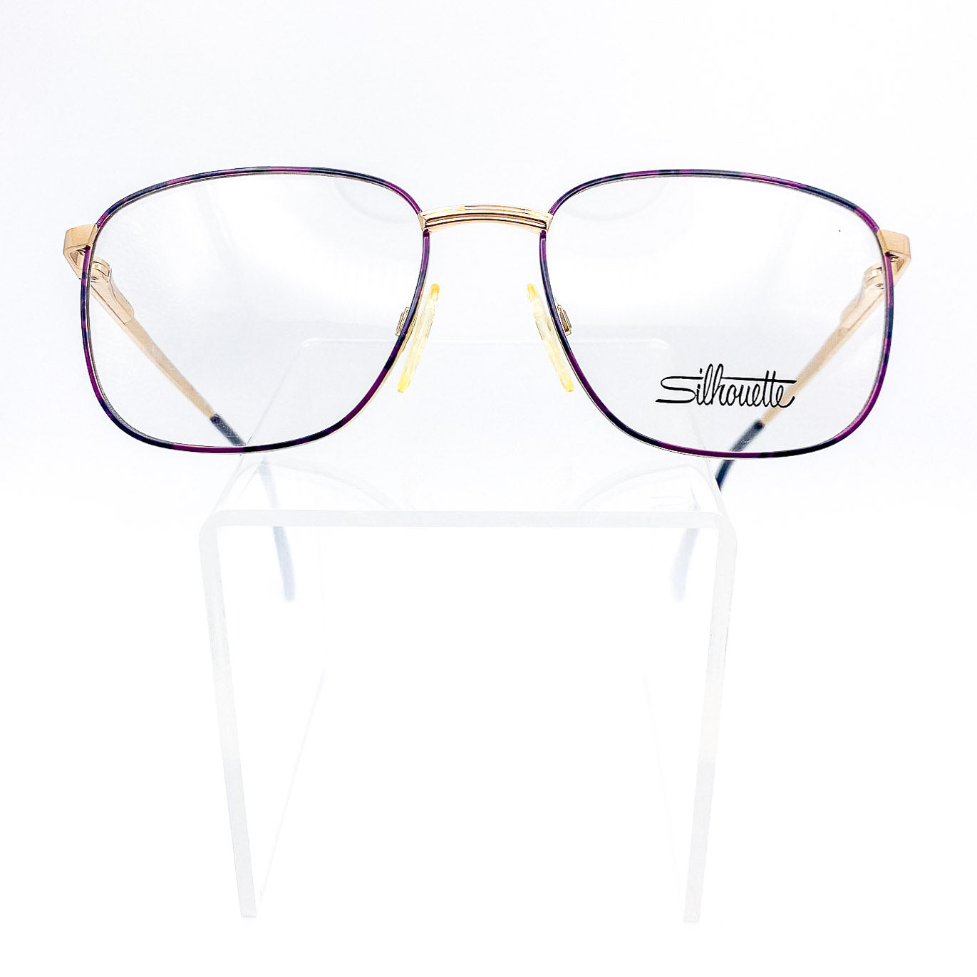 Silhouette eyeglasses with purple and gold frame on a white background