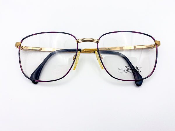 Gold and purple Silhouette eyeglasses on a white background