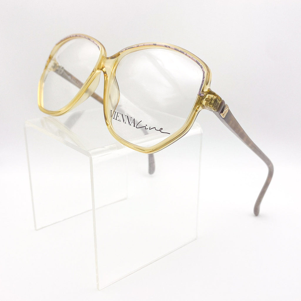 Gold-framed eyeglasses on a white background
