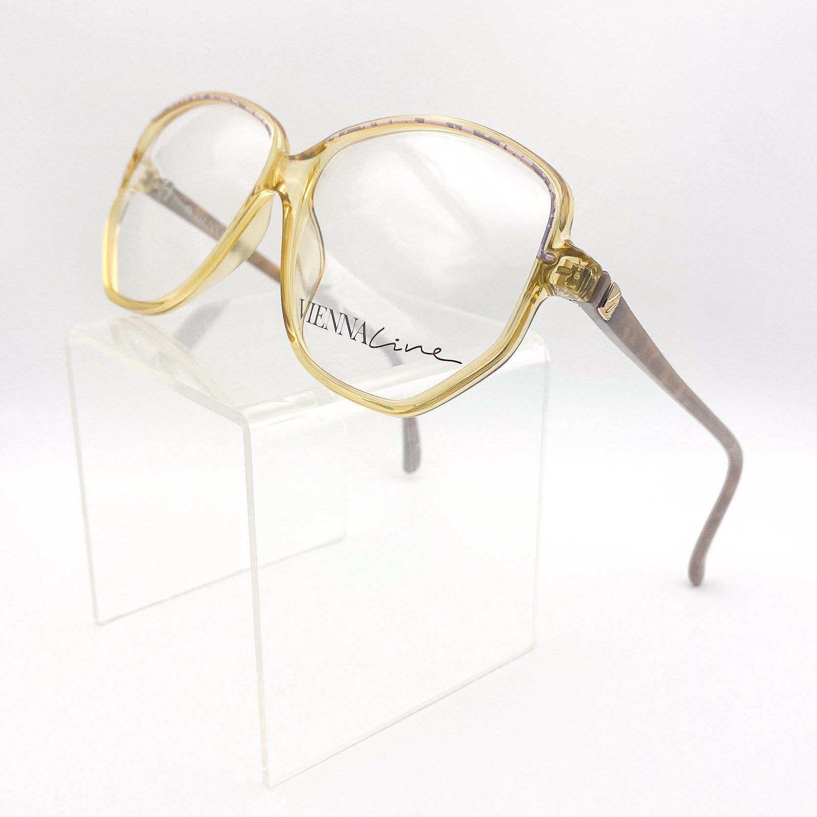 Gold-framed eyeglasses on a white background