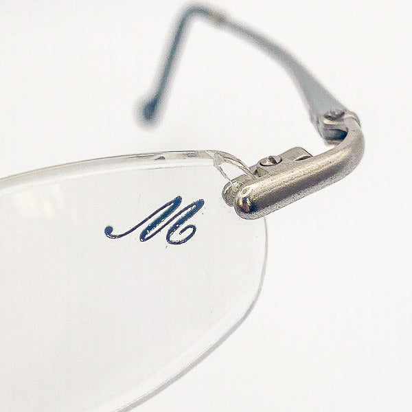 Close-up of eyeglasses with a visible brand logo on a white background