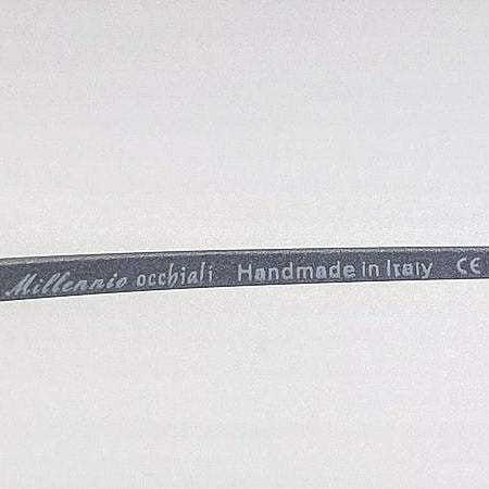 Eyeglass frame label with 'Millennio occhiali' branding on a white background