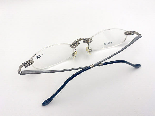 1990s silver rimless eyeglasses on a white background