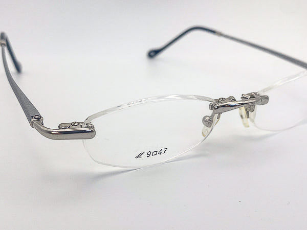 Silver rimless eyeglasses on a white background