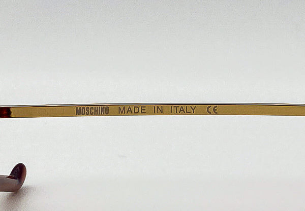 Eyeglass frame with 'Moschino Made in Italy' inscription on a white background