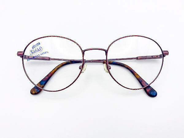 1990s Safilo eyeglasses in a burgundy metal frame on a white background