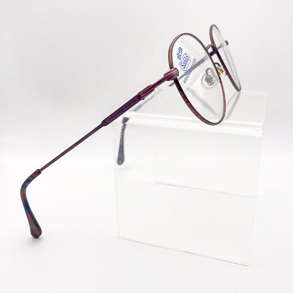 Eyeglasses with a wine-colored frame on a white background