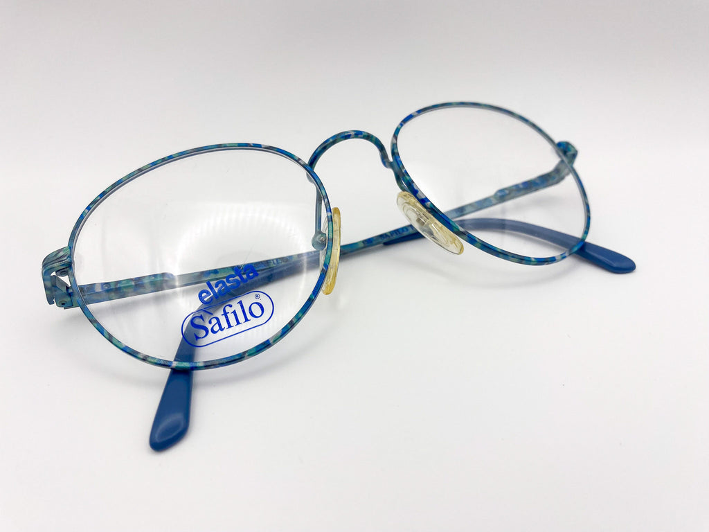 Vintage round eyeglasses with 'Safilo' branding on a white background