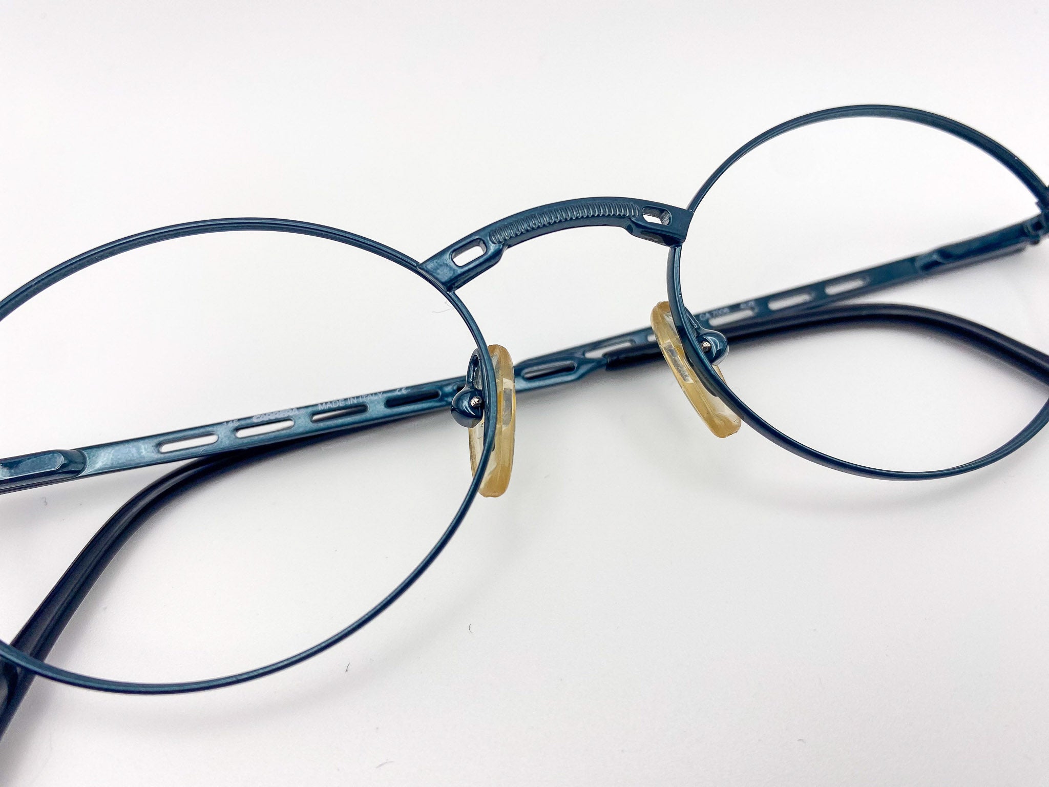 Teal blue eyeglasses on a white background