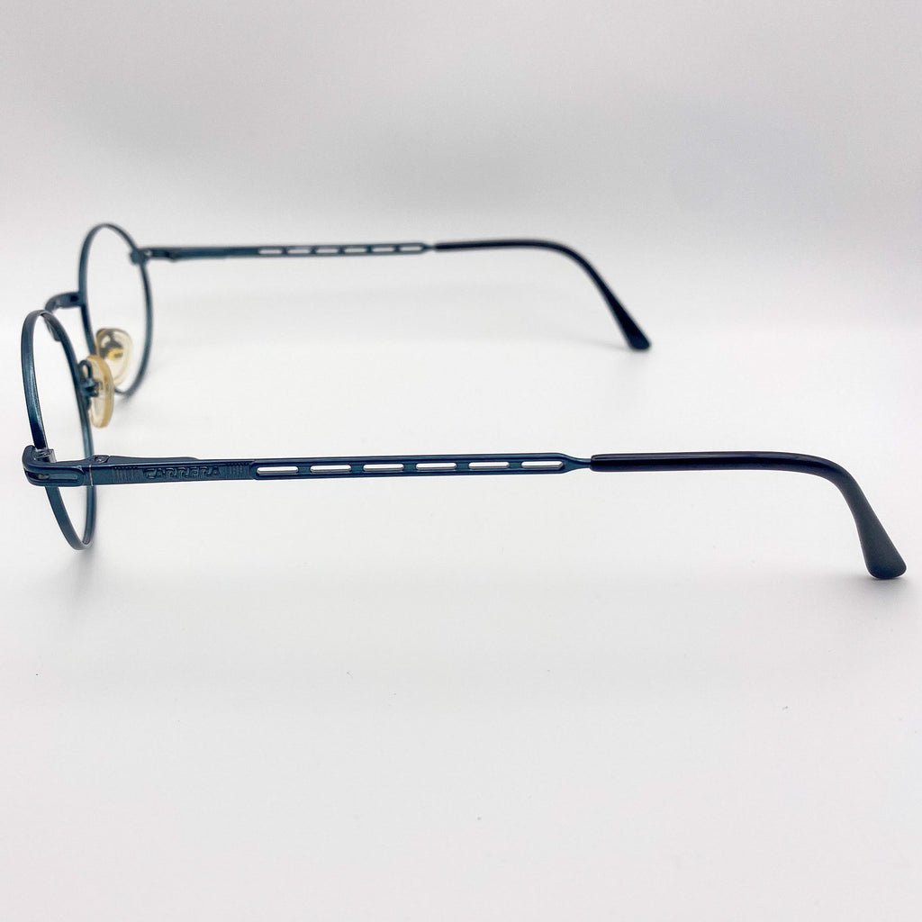 Teal blue eyeglasses on a light gray background