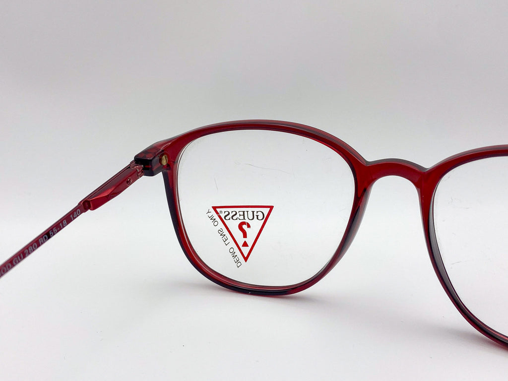 Red eyeglasses with a clear lens featuring a brand logo on a white background