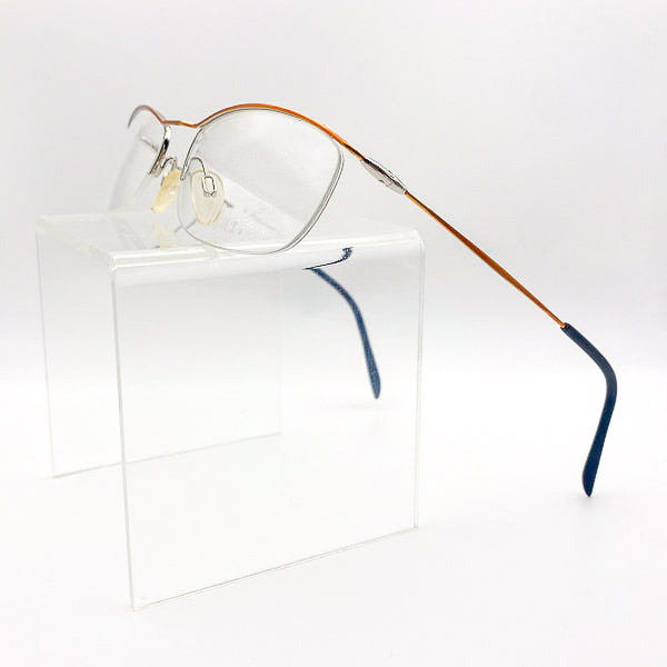Eyeglasses with a gold frame and black accents on a white background
