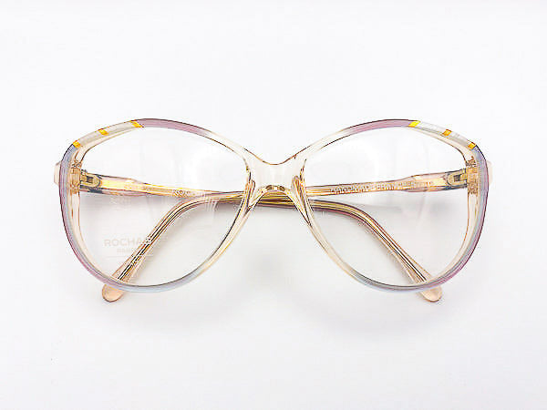 Vintage Rochas Paris gold and lavender eyeglasses on a white background