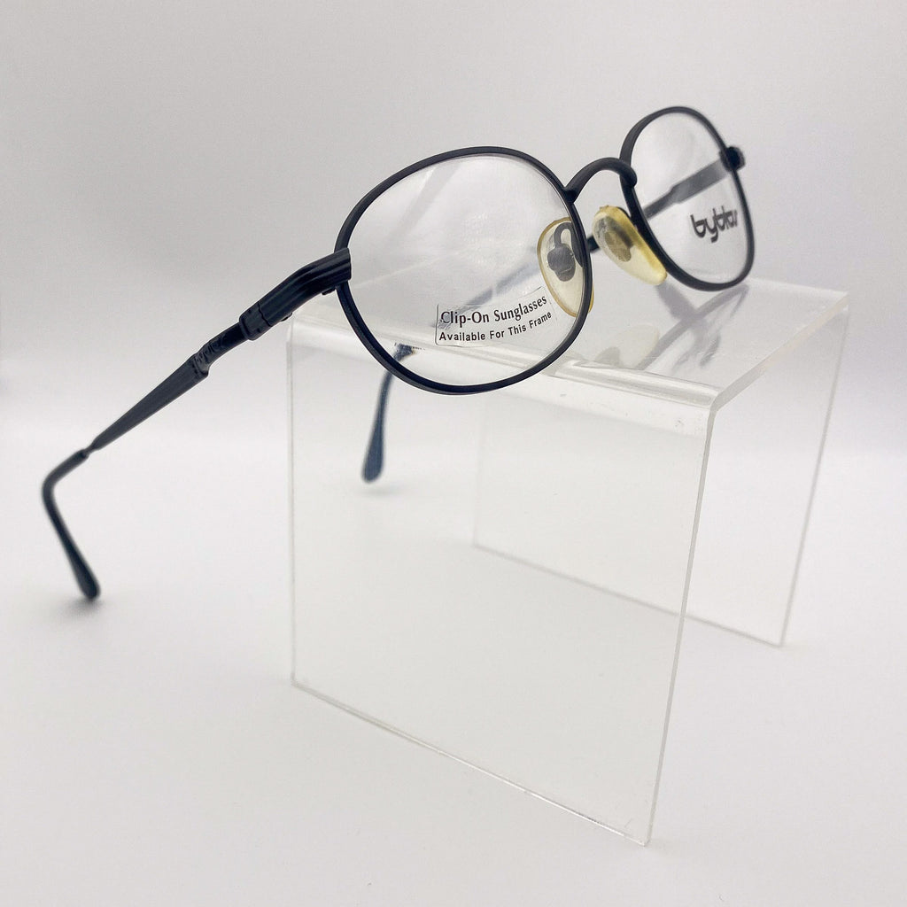 Eyeglasses with clip-on sunglasses on a white background