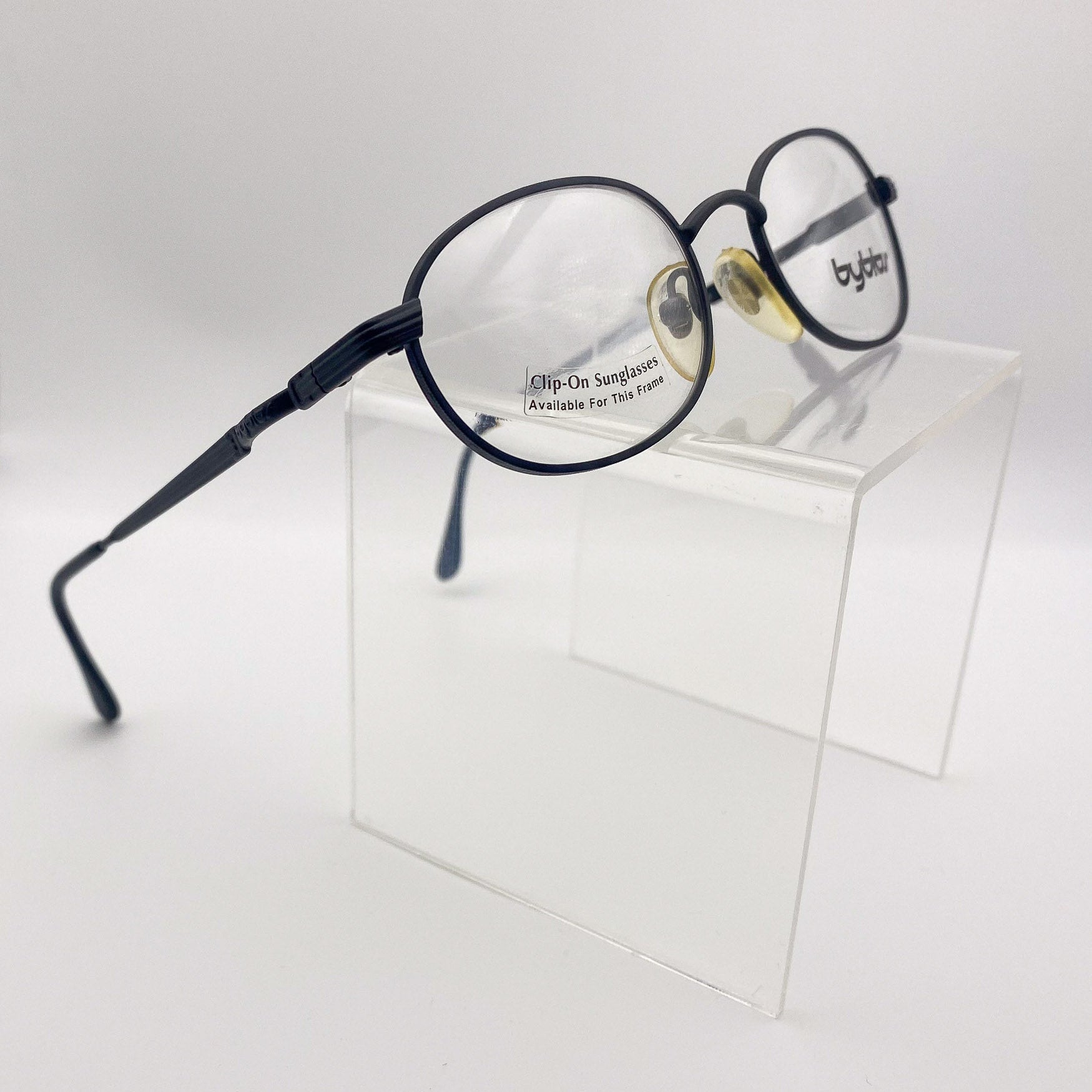 Eyeglasses with clip-on sunglasses on a white background