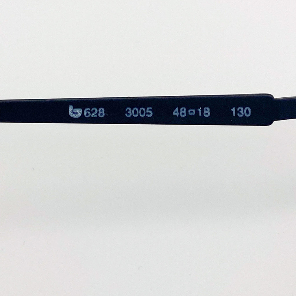 Close-up of a black eyeglass frame with engraved measurements on a white background