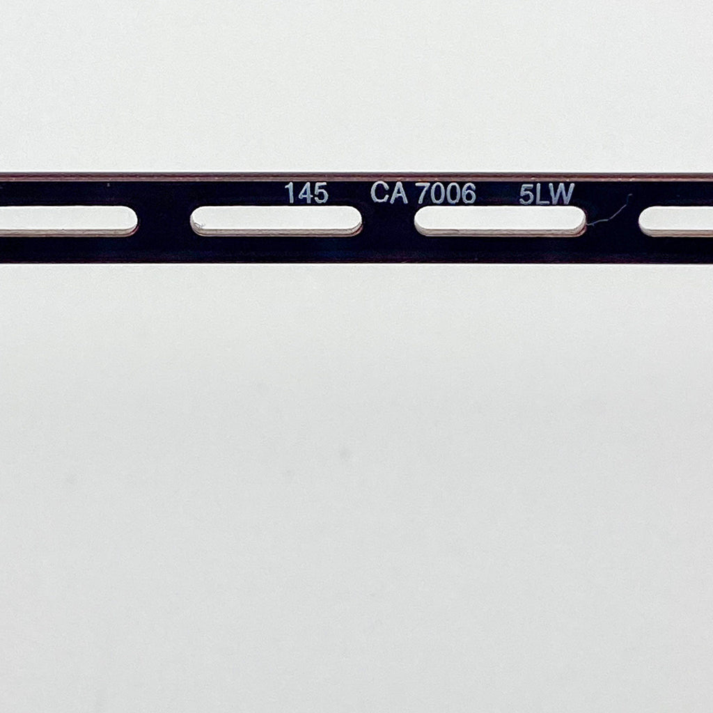 Close-up of a temple arm with engraved text on a white background