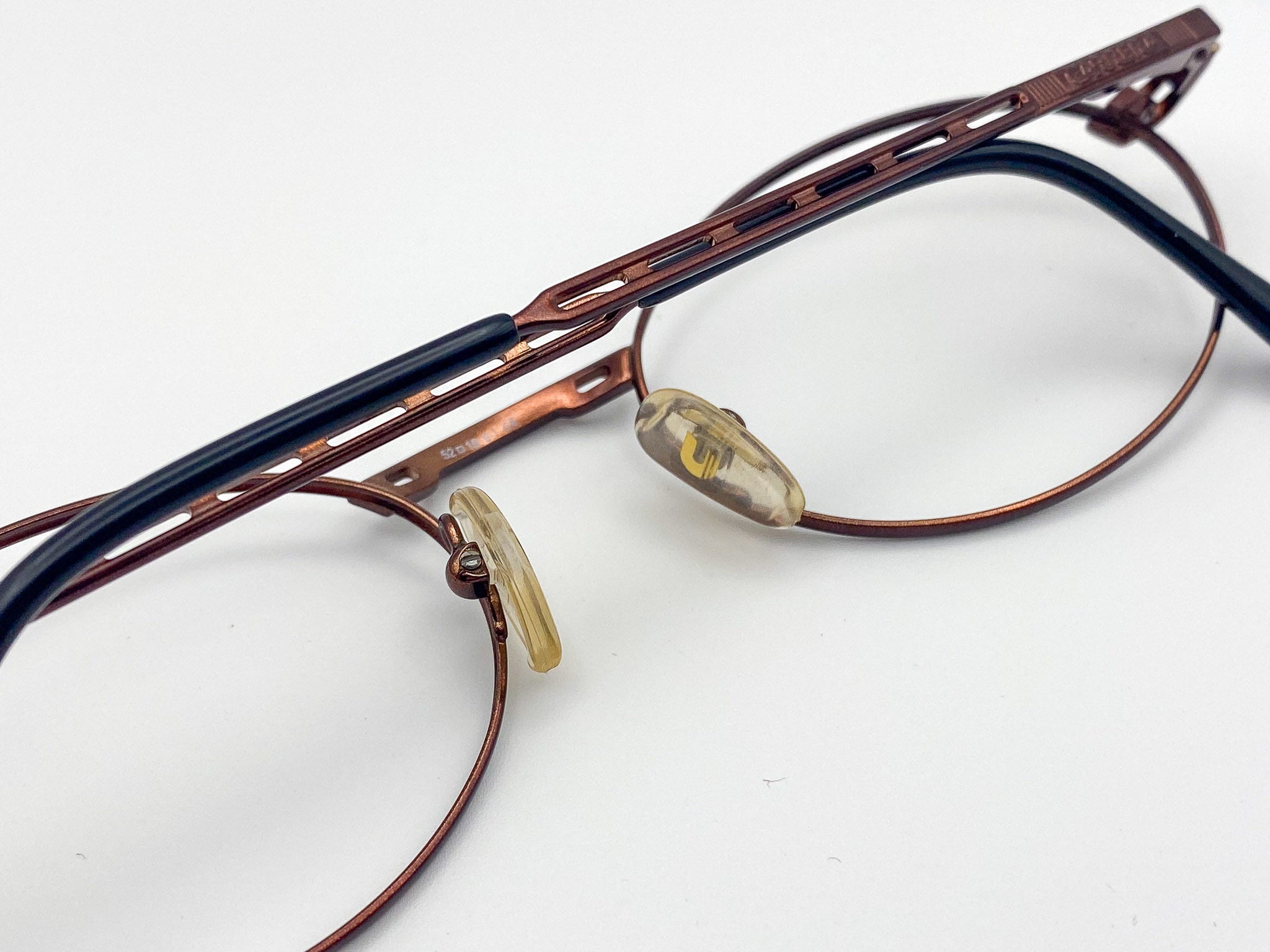 Pair of eyeglasses with a burgundy frame on a white background