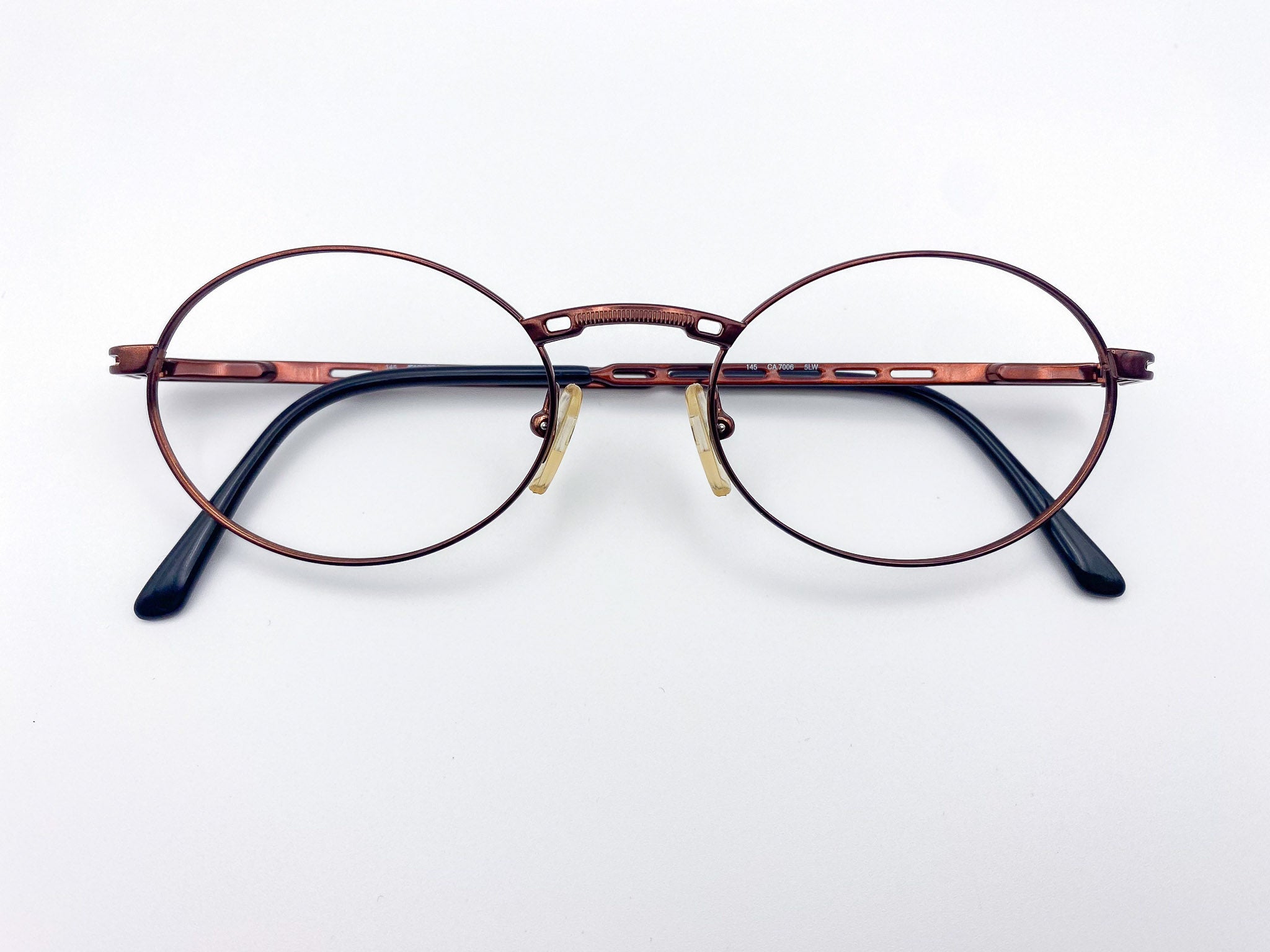 1990s Carrera burgundy metal round eyeglasses on a white background