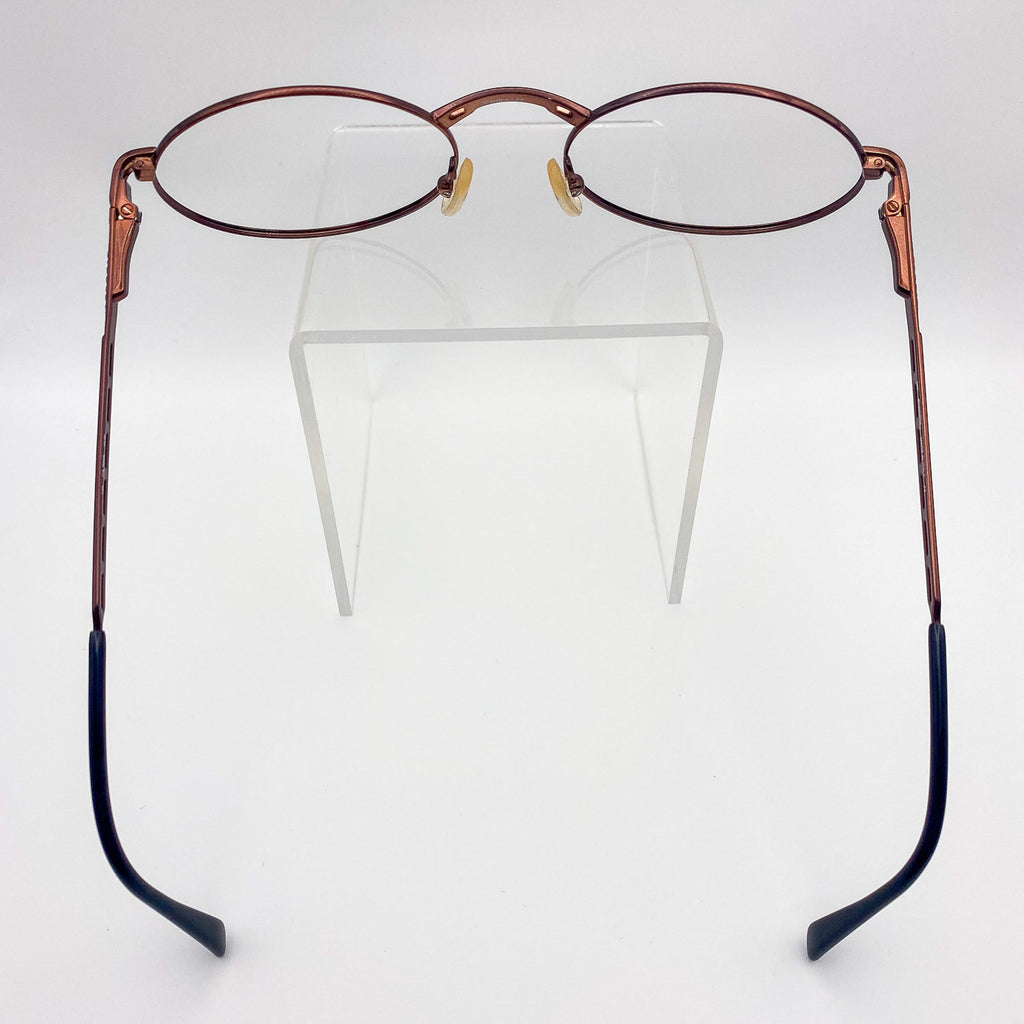 Pair of eyeglasses with wine-colored frames and black arms on a white background