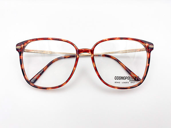 1980s tortoiseshell eyeglasses with Cosmopolitan Eyewear logo on a white background