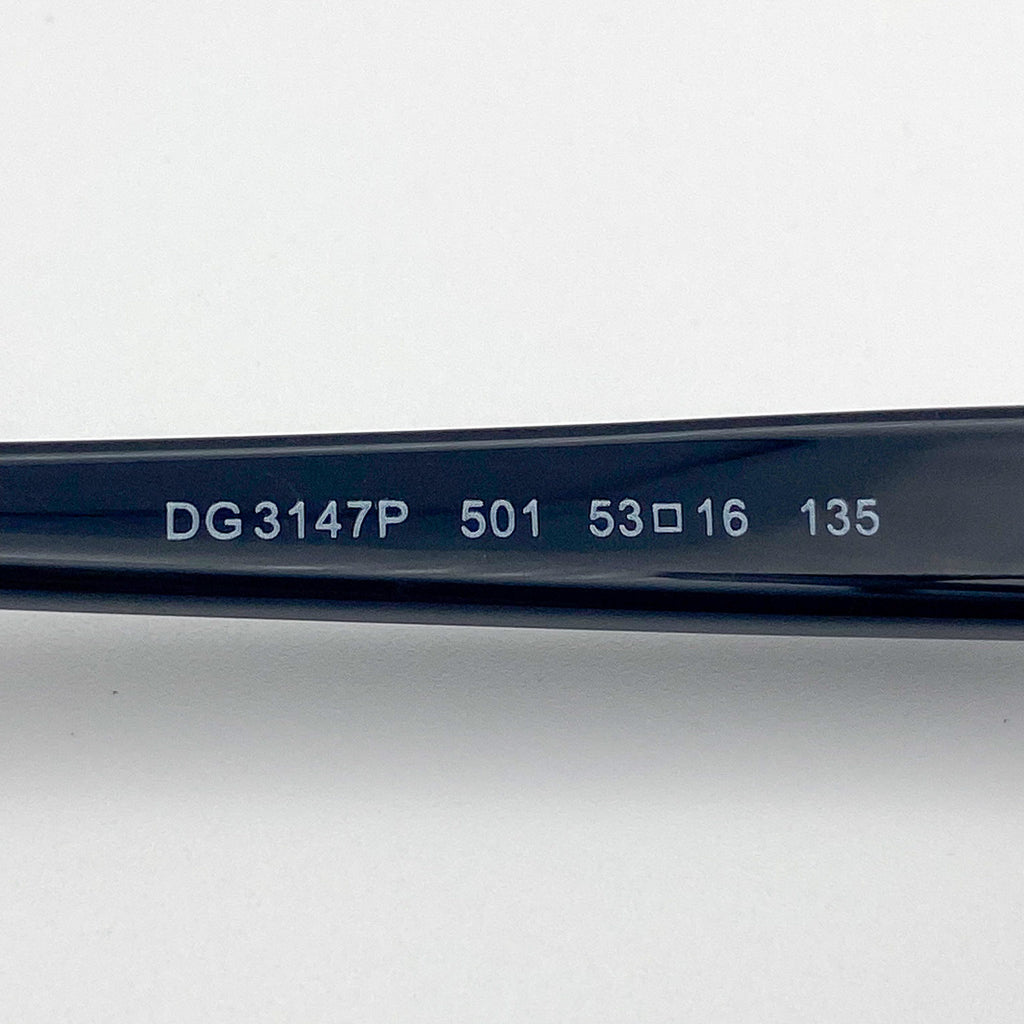 Close-up of a black eyeglass frame with serial number on a light gray background