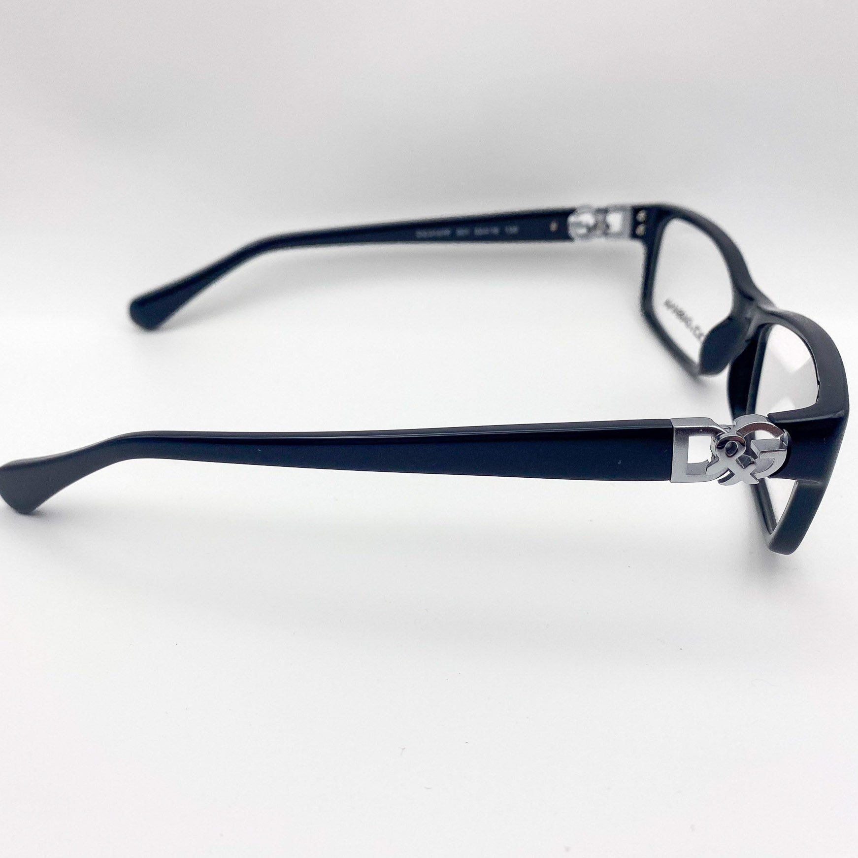 Black eyeglasses with silver accents on a white background