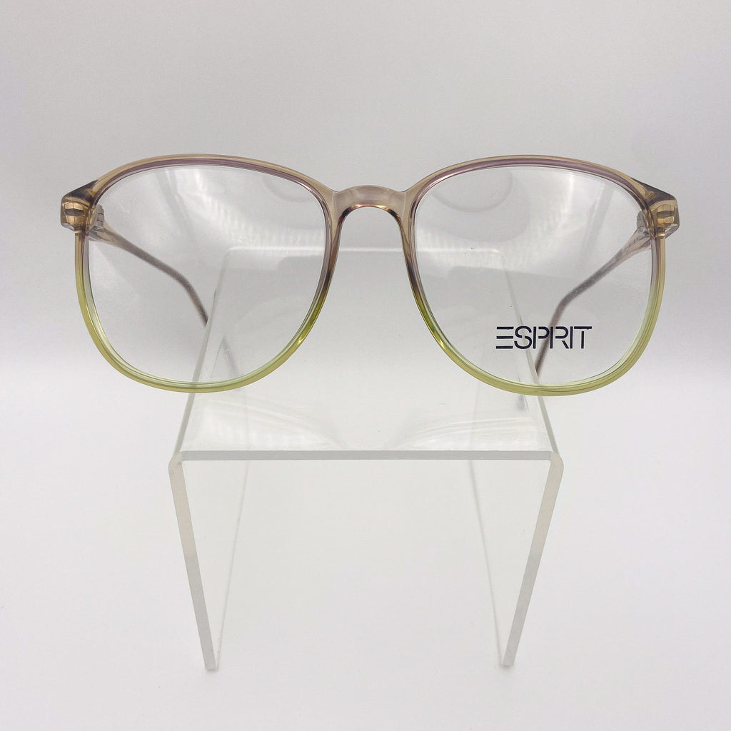 1980s eyeglasses with a gradient design on a clear stand against a white background