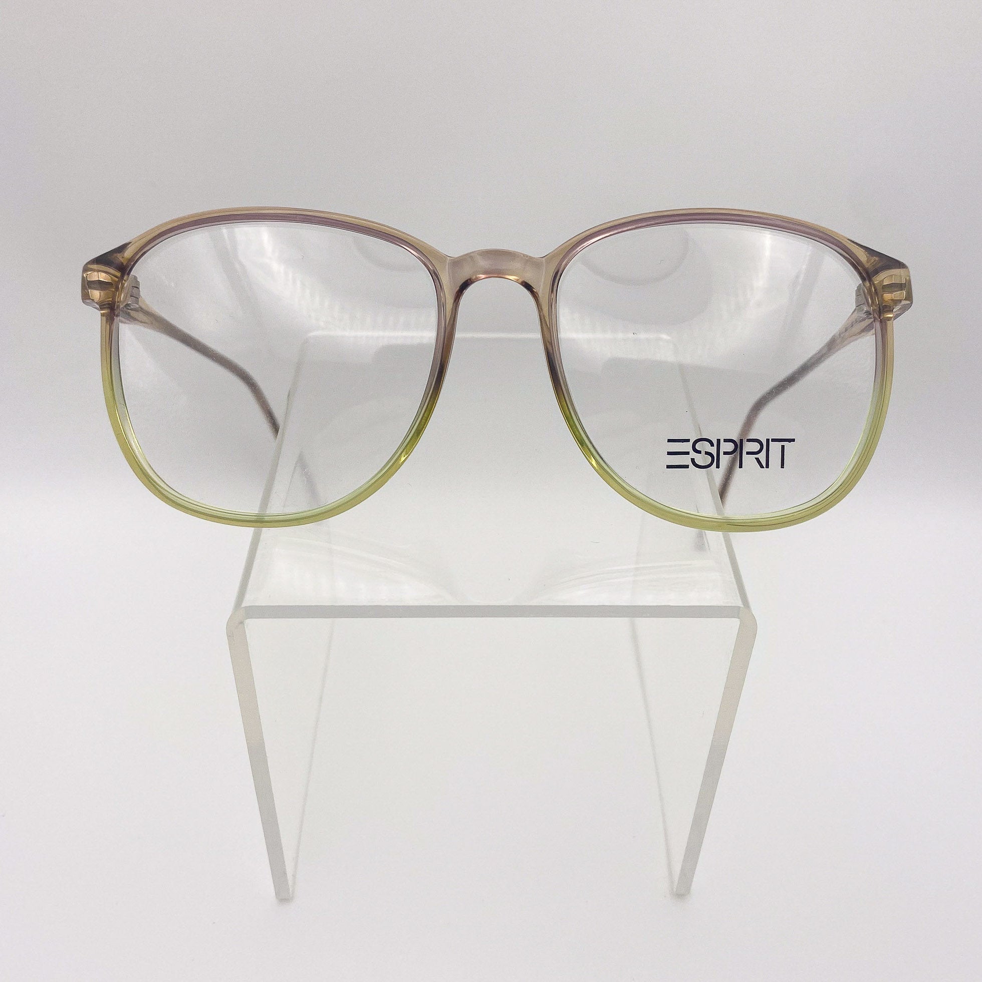 1980s eyeglasses with a gradient design on a clear stand against a white background