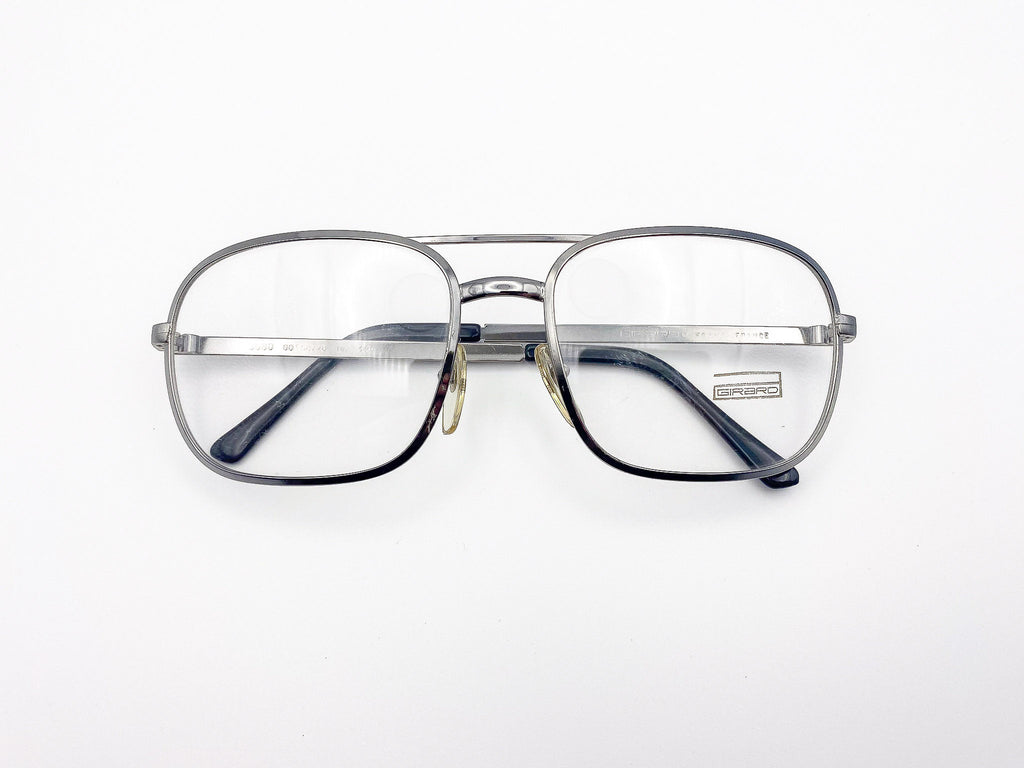 Vintage Girard silver aviator eyeglasses on a white background