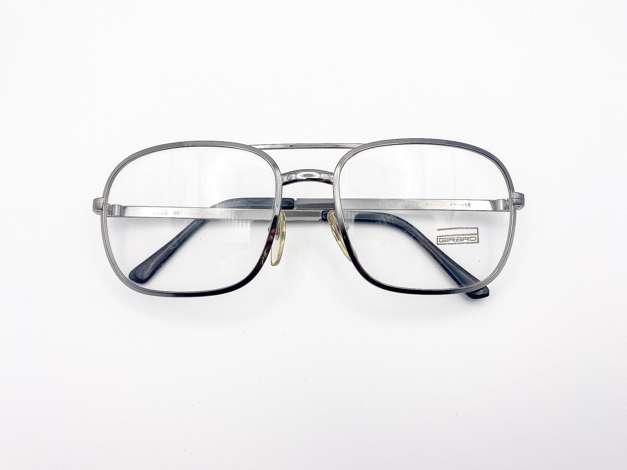 Vintage Girard silver aviator eyeglasses on a white background